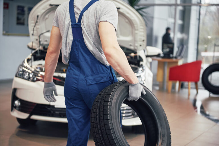 Mechanic holding a tire tire at the repair garage